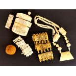 A group of Oriental carved bone items and a carved walnut shell.