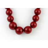 A graduated red bead necklace, L. 50cm.