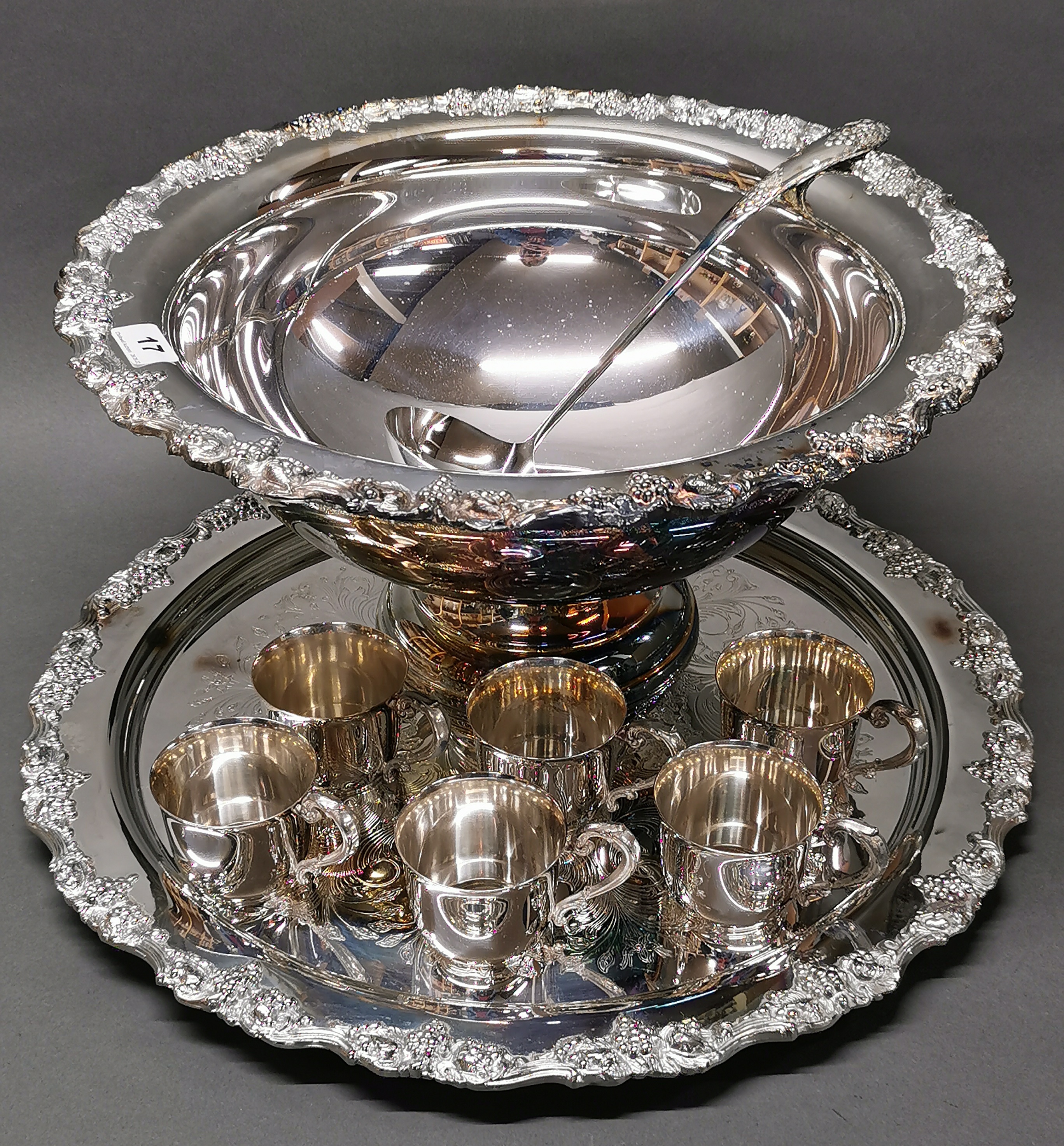 A large silver plated punch bowl, Dia. 45cm, with twelve silver plated punch cups and a large silver