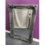 A large silvered framed bevelled glass mirror, 88 x 121cm.