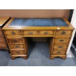 An attractive leather topped desk, W. 121cm.