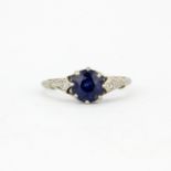 An Art Deco 18ct white gold (stamped 18ct) ring set with a round cut natural sapphire and diamond