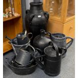 A quantity of black painted garden metal and pottery items, tallest H. 76cm.