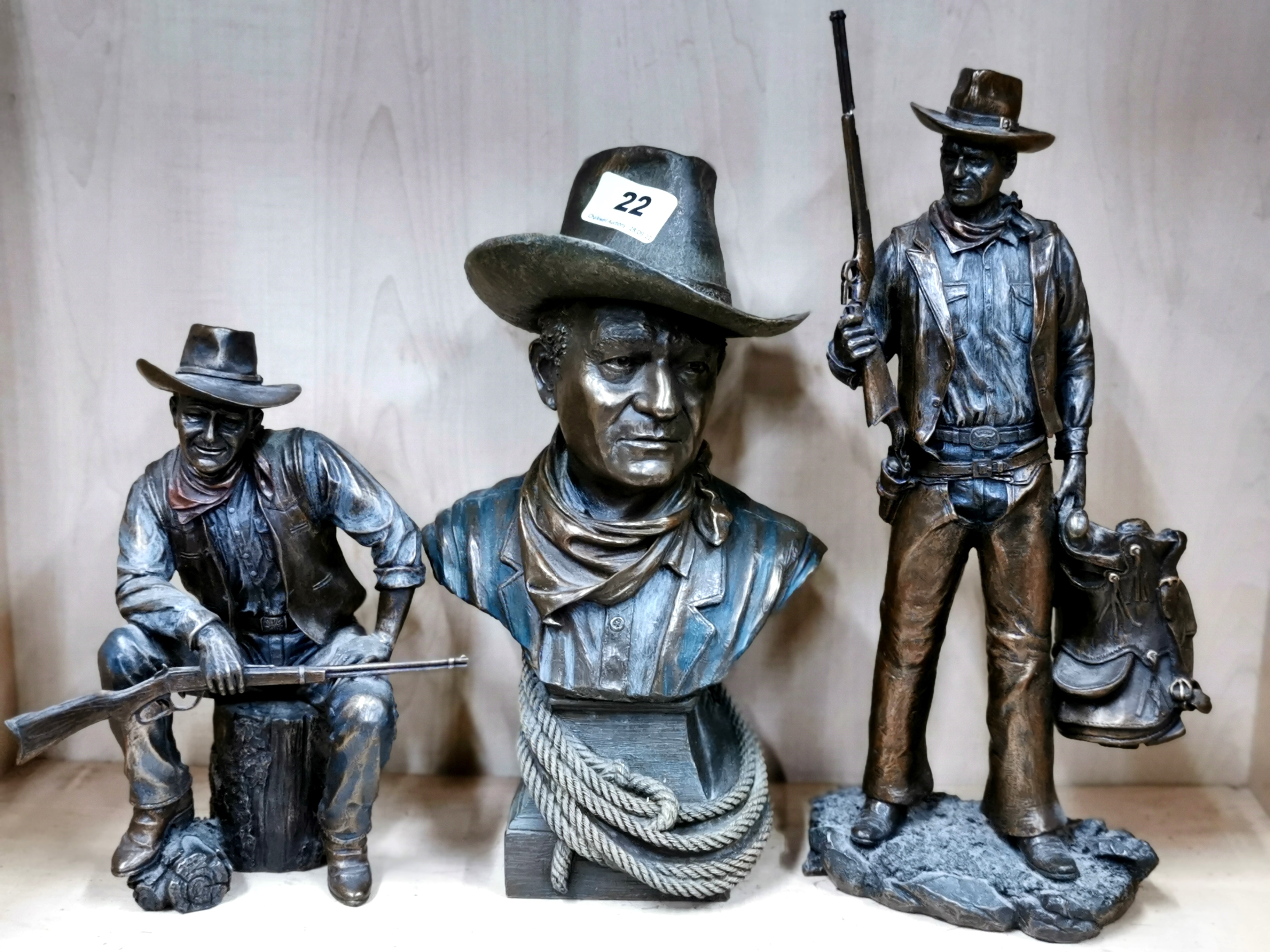 A group of three cold cast figures of John Wayne, tallest H. 36cm (one gun slightly A/F).