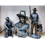 A group of three cold cast figures of John Wayne, tallest H. 36cm (one gun slightly A/F).