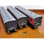 A quantity of 'O' gauge tin plate rolling stock with an incomplete locomotive.