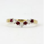 A 9ct yellow gold ruby and diamond set wishbone ring, (L).