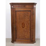 An 18th century inlaid oak and walnut veneered corner wall cabinet, H. 105cm.