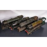 A group of four early tin plate 'O' gauge electric locomotives.