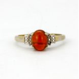 A 925 silver ring set with a cabochon cut fire opal and diamond set shoulders, (S.5).