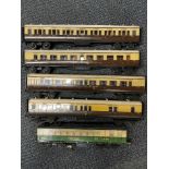 A group of four 'O' gauge wooden passenger carriages plus a further LNER.