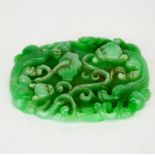 A Chinese carved jade amulet of two young dragons with lotus, 11 x 9 x 1cm.