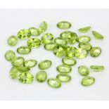 A quantity of unmounted natural oval cut peridot, approx. 30.47ct total.