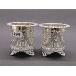 A pair of silver plated wine bottle coasters, H. 12cm.