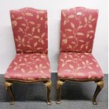 A pair of upholstered giltwood bedroom chairs.