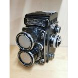 A Rolleiflex twin lens reflex camera.