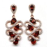 A pair of rose gold on 925 silver drop earrings set with marquise cut garnets and white stones, L.