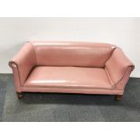 A 1920's child's leather upholstered drop end settee, L. 130cm, H. 51cm.