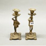 A pair of brass figural candlesticks, H. 20cm.