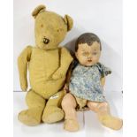 A large articulated teddy bear, H. 65cm, and composition doll.