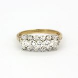 A hallmarked 9ct yellow gold ring set with round cut cubic zirconias, (T.5).