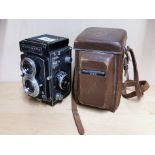 A Ricohmatic 225 twin lense reflex camera with leather case.