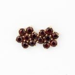 A pair of hallmarked 9ct yellow gold stud earrings set with round cut garnets, L. 1cm.