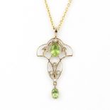 An Edwardian 9ct yellow gold pendant set with peridot and seed pearls on a 9ct yellow gold chain, L.