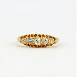 A hallmarked 18ct yellow gold ring set with graduated old brilliant cut diamonds, (Q).