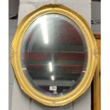 An oval gilt framed mirror, 49 x 59cm.