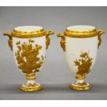 A pair of fine Coalport gilt white porcelain urns, H. 13cm. Restoration to one handle.