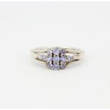 A 925 silver ring set with graduated round cut tanzanites, (N).