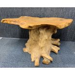 An interesting rustic tree trunk coffee table, W. 95cm. H. 44cm.