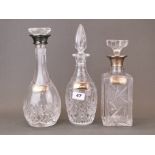 Two hallmarked silver mounted cut glass decanters with a further decanter and three hallmarked