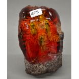 A large boulder of faux amber with insects, H. 23cm.