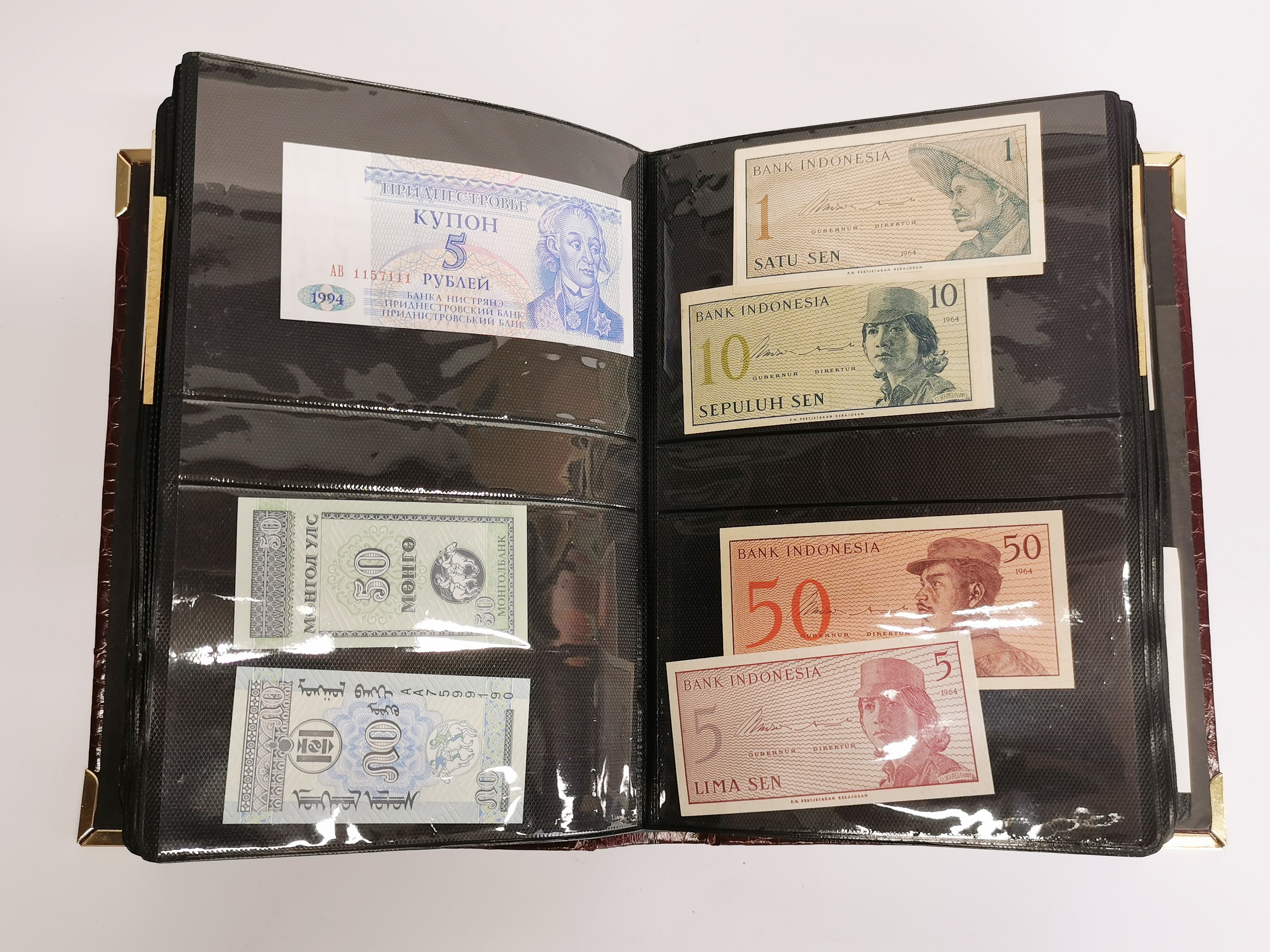 An album of mixed bank notes.