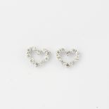 A pair of 18ct white gold diamond set heart shaped stud earrings, L. 0.7cm.