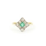 An antique 18ct yellow and white gold ring set with a square cut emerald surrounded by diamonds, (