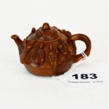 A Chinese carved fruitwood teapot decorated with eight lucky gods, W. 8cm. D. 5cm.