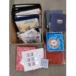 A box of mixed stamps and albums.