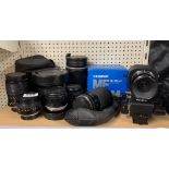 A group of mixed camera lenses.