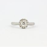 An 18ct white gold and platinum halo ring set with brilliant cut diamonds, approx. 0.34ct total,