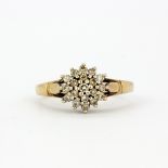 A hallmarked 9ct yellow gold diamond set cluster ring, (S).
