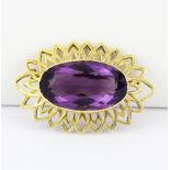 An 18ct yellow gold (tested) brooch set with a large oval cut amethyst, L. 4.7cm.