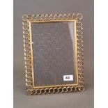 A lovely 1920's brass picture frame with bevelled glass, 23 x 30cm.