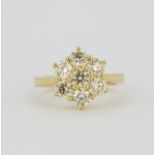 An 18ct yellow gold daisy cluster ring set with large brilliant cut diamonds, approx. 2.30ct