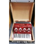 A vintage cased piano accordian.