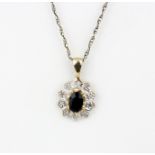 A 9ct yellow gold sapphire and diamond set pendant on a 9ct yellow gold chain, L. 46cm.