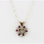A hallmarked 9ct yellow gold diamond and ruby set heart pendant on a 9ct yellow gold chain, L.