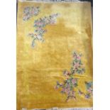 A large Chinese gold ground washed wool carpet, W. 273cm.